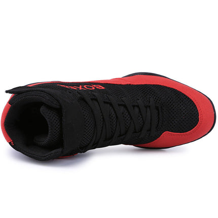 Red and black indoor training boxing shoes with mesh design and rubber sole.