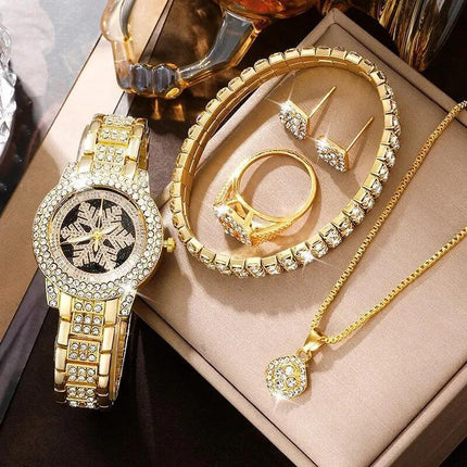 Luxurious gold jewelry set with snowflake pattern watch, necklace, earrings, ring, and bracelet.